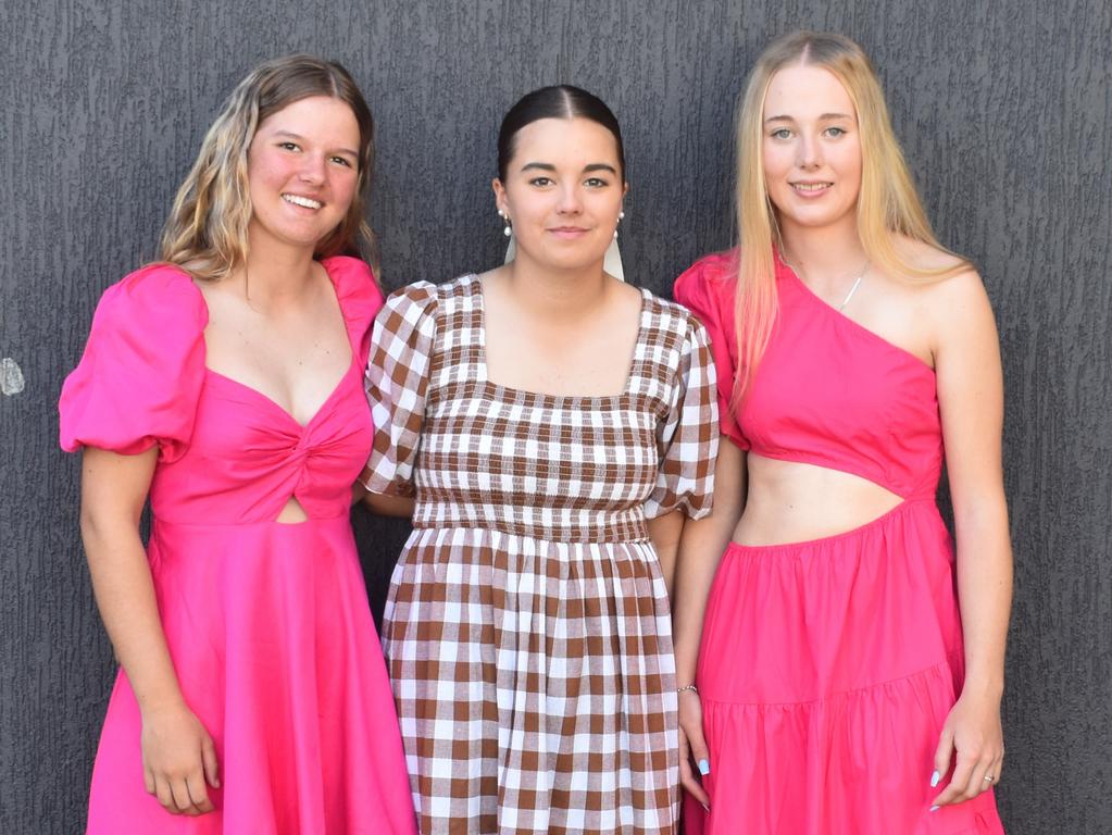 Francesca Dooley, McKayla Barnes and Ariana Upton at the Rockhampton Jockey Club's Pink Ribbon Stradbroke Charity Race Day at Callaghan Park on June 15, 2024.