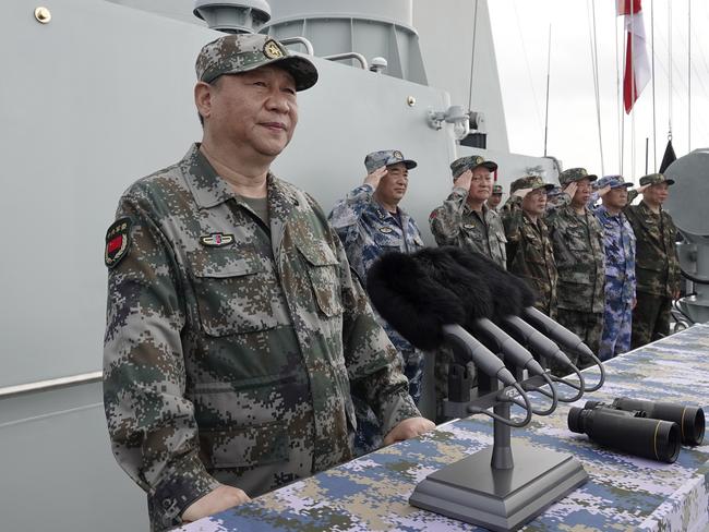 FILE - In this April 12, 2018, file photo released by Xinhua News Agency, Chinese President Xi Jinping, left, speaks after he reviewed the Chinese People's Liberation Army (PLA) Navy fleet in the South China Sea. From Asia to Africa, London to Berlin, Chinese envoys have set off diplomatic firestorms with a combative defense whenever their country is accused of not acting quickly enough to stem the spread of the coronavirus pandemic. (Li Gang/Xinhua via AP, File)