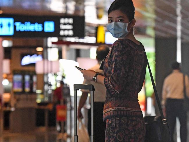 A Singapore Airlines stewardess returns from a flight at Changi International Airport terminal in Singapore on June 8, 2020, as Singapore prepares to reopen its borders after shutting them to curb the spread of the COVID-19 novel coronavirus. (Photo by Roslan RAHMAN / AFP)