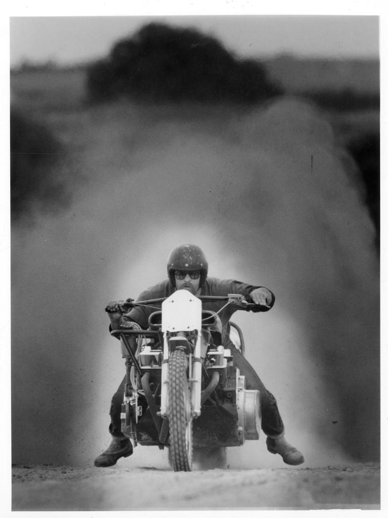 Mechanic Neil Walden at Ponde astride a purpose-built sand dragging motorcycle with a 327 cu in Chevrolet V8 engine preparing for the sand drag motor cycle races that are a highlight of the Ponde 94 rock festival, 17 Feb 1994.