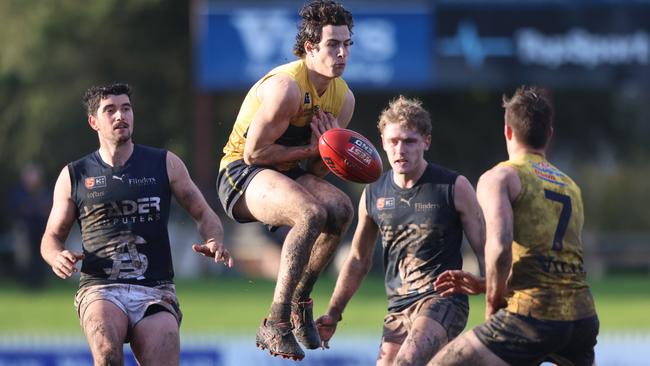 Woodville-West Torrens’ Jake Comitogianni jumps high but spills the mark in the muddy conditions at Woodville Oval. Picture: Cory Sutton/SANFL.