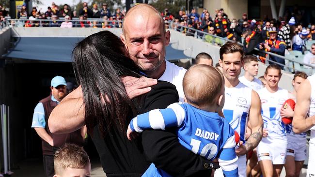 ADELAIDE, AUSTRALIA - AUGUST 13: Ben Cunnington of the Kangaroos walks out with his family during the 2022 AFL Round 22 match between the Adelaide Crows and the North Melbourne Kangaroos at Adelaide Oval on August 13, 2022 in Adelaide, Australia. (Photo by James Elsby/AFL Photos via Getty Images)