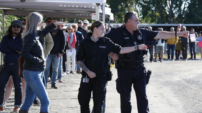 Security and police assisted the line for vaccinations at Rocklea Showgrounds Covid hub. Picture: Annette Dew