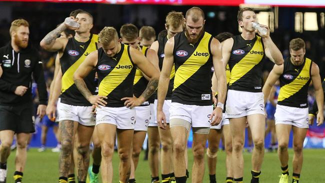 Disappointed Richmond players leave Etihad Stadium after the five-point loss. Picture: Michael Klein