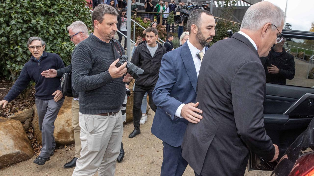 Prime Minister Scott Morrison is bundle into a vehicle as members of his security detail keep Trevor Sofield from approaching. Picture: Jason Edwards