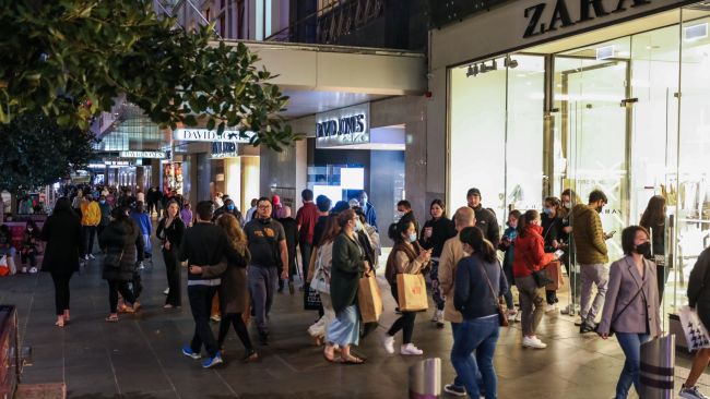 Evening shoppers are seen in Melbourne's Bourke Street Mall on Friday night after further restrictions were eased. Picture: Getty Images