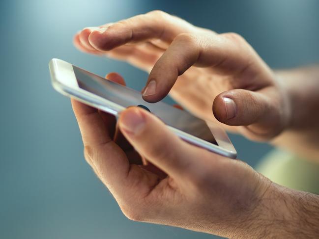 Male hands typing on smartphone. Picture: Istock