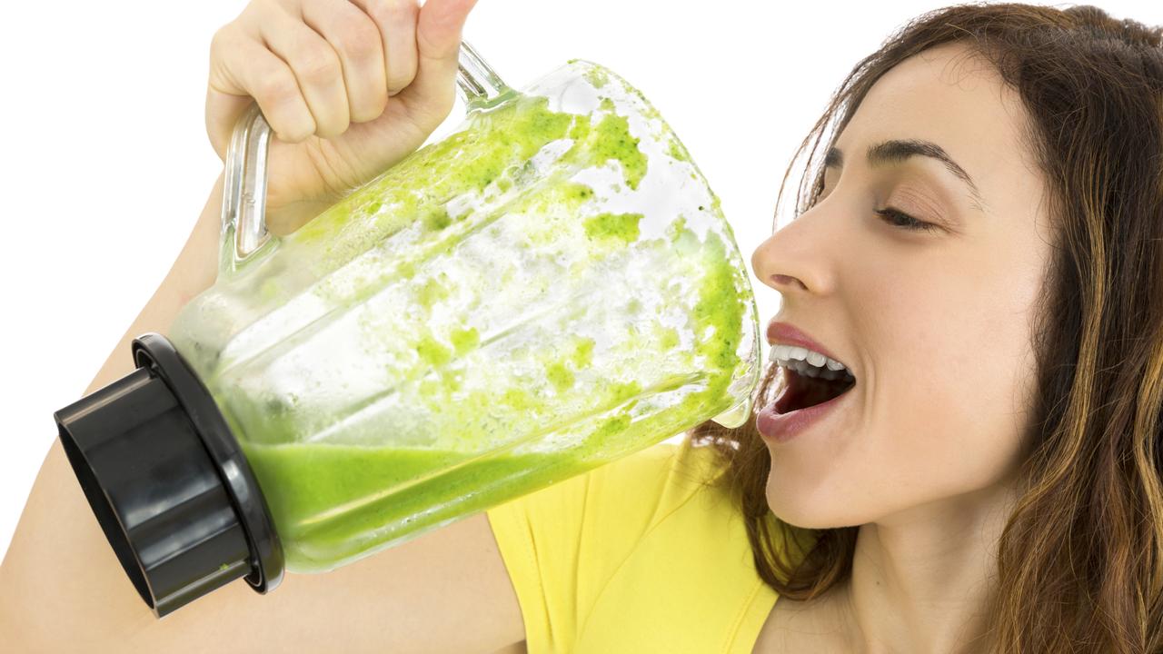 woman guzzling green smoothie generic image