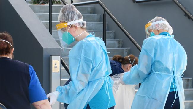 NSW Health workers conducting Covid tests at a unit block at Sturt Rd, Cardiff. Picture: Emily Burley.