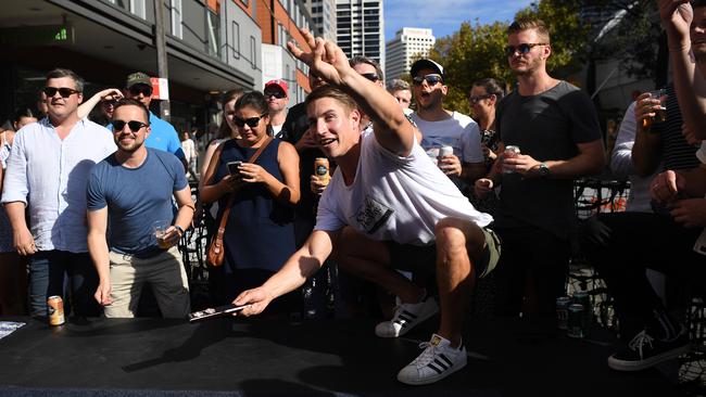 Patrons take part in a traditional game of Two-Up on Anzac Day. Picture: AAP Image/Joel Carrett