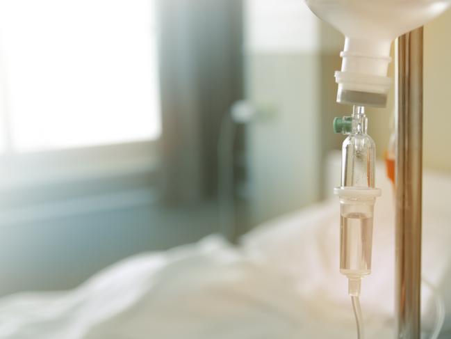 Saline solution in a patient's hand in the hospital. iStock image