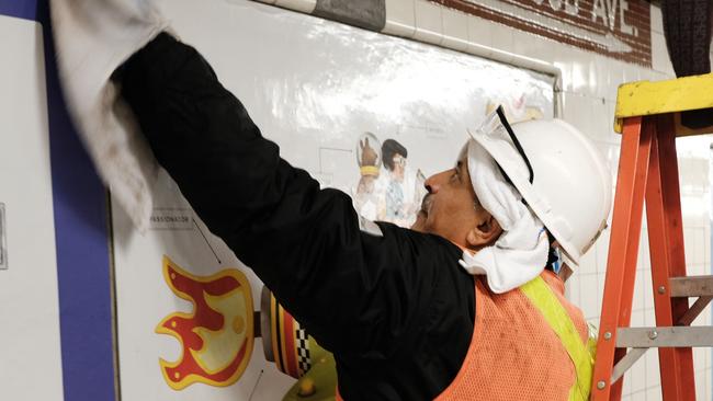 Workers clean a subway station in Brooklyn as New York City confronts the coronavirus outbreak on March 11.