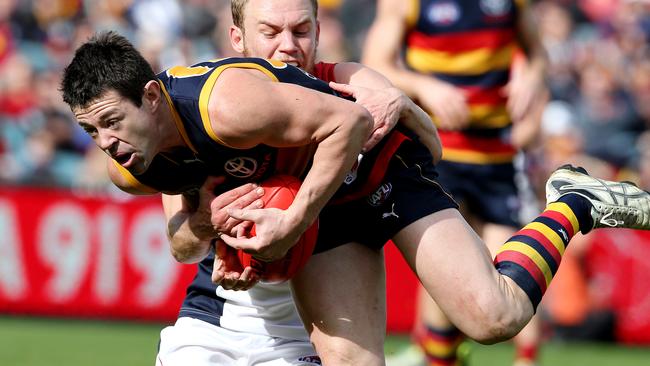 AFL – Adelaide Crows v Melbourne, AAMI Stadium. Ian Callinan gets tackled by Dean Terlich. Picture: SARAH REED