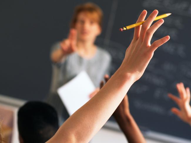 Teacher pointing to raised hands in classroom, Classroom, teaching generic, education generic, Teacher, Learning, Hand Raised, Education, Adult, School Building, Pointing, Standing, Image, Women, Adults Only, Colour Image, Horizontal, Human Arm, Human Body Part, Human Limb, Incidental People, Indoors, Limb, One Person, Only Women, People, Photography, thinkstock, generic, istock