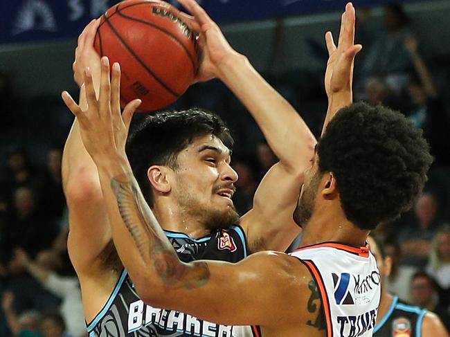 Shea Ili of the Breakers is challenged by Melo Trimble of the Taipans on Friday night.