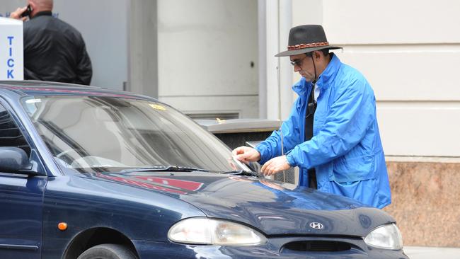 A car being issued with a parking fine in Pirie St.