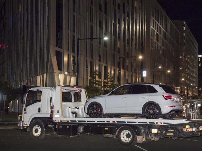 Police remove an Audi from an apartment block in Docklands. Picture: Jason Edwards