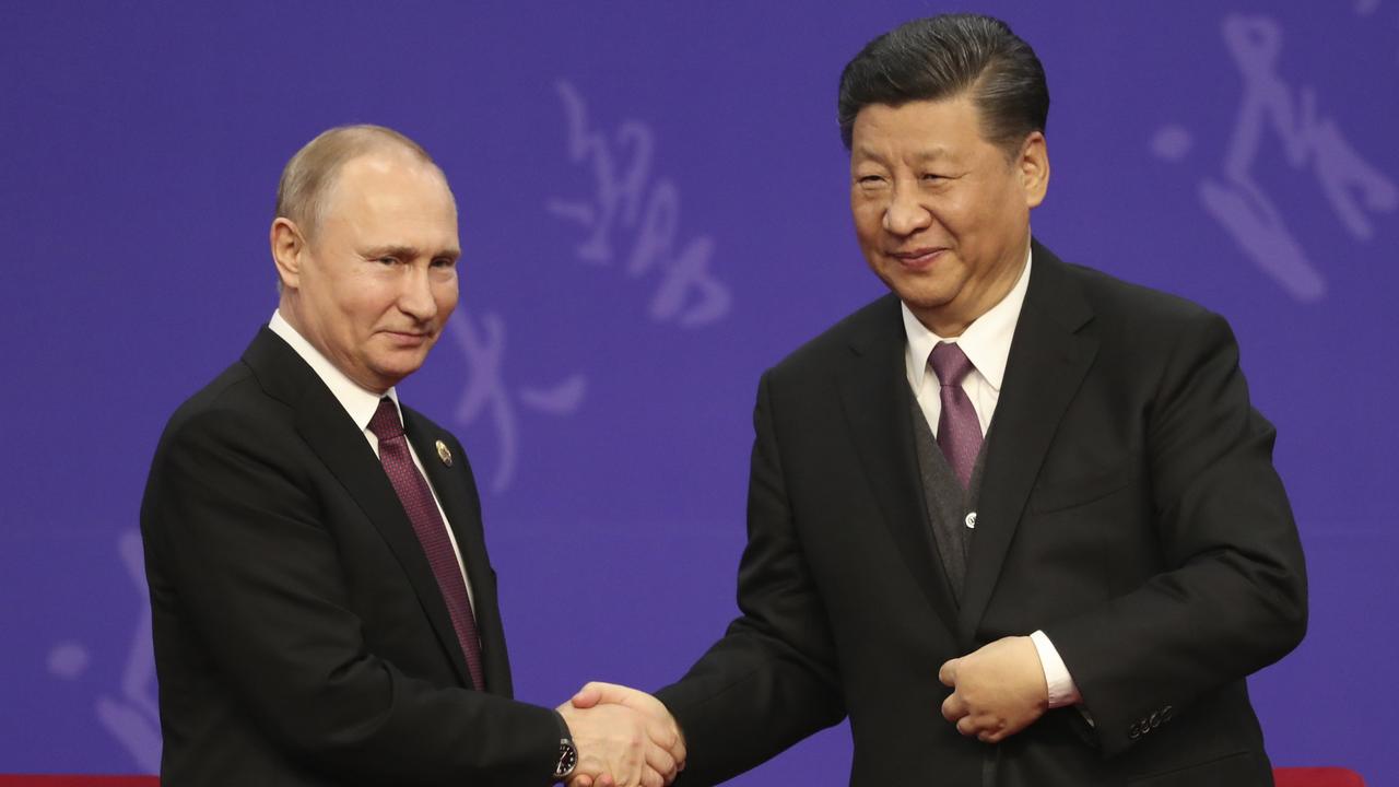 Russian President Vladimir Putin shakes hands with Chinese President Xi Jinping. Putin has secured military support from Iran and North Korea and economic support from China and India. Picture: Kenzaburo Fukuhara