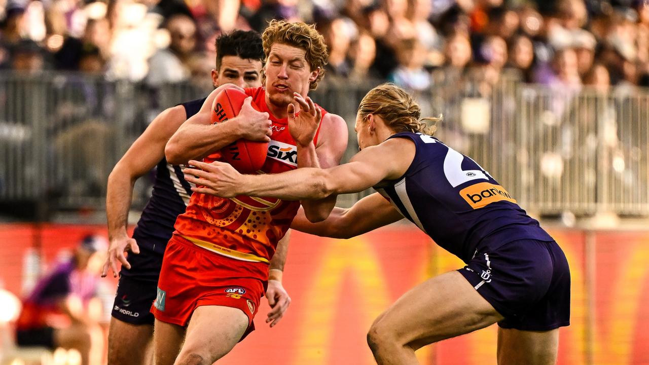 Matt Rowell runs into a Hayden Young tackle. Picture: Daniel Carson/AFL Photos via Getty Images