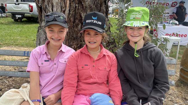 Kayley Schneider, 13, of Culcairn, Jasmine Lieschke, 13, of Holbrook, and Zoe Wilson, 13, of Jindera, catch up at Henty Machinery Field Days. Pictures: Nikki Reynolds