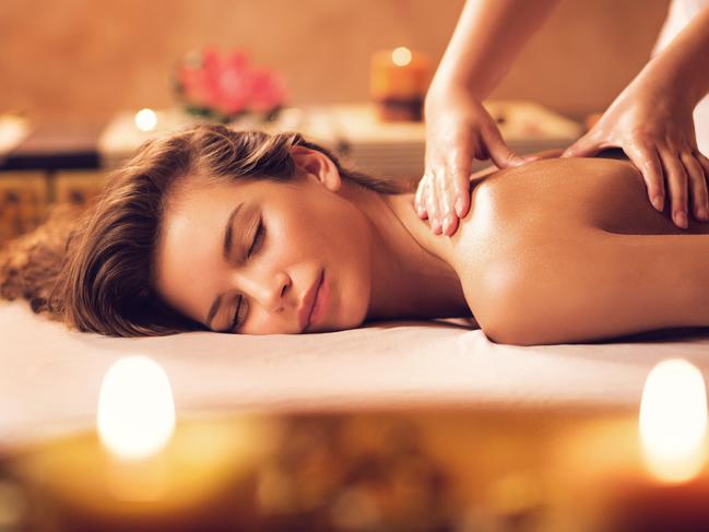 Beautiful woman receiving back massage at the spa.