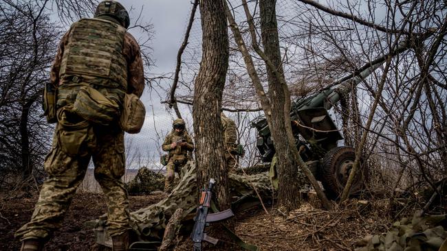 Ukrainian servicemen prepare to fire a Msta-B howitzer towards Russian positions, near the frontline town of Bakhmut, on Friday. Picture: Dimitar Dilkoff / AFP