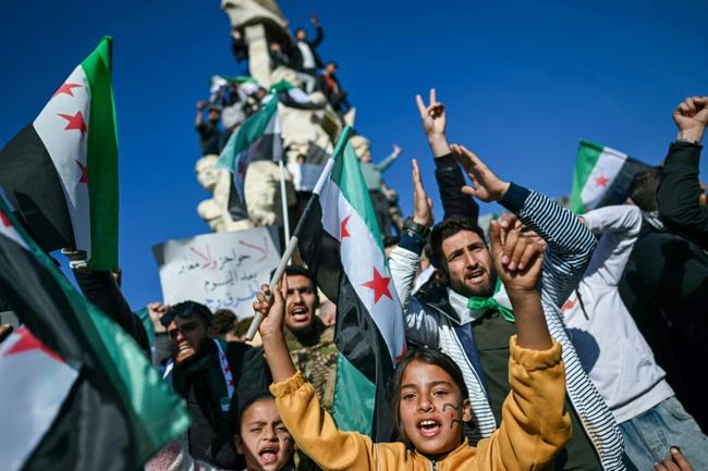 People in Syria's Aleppo celebrate the fall of Assad during rallies called the 'Friday of victory'