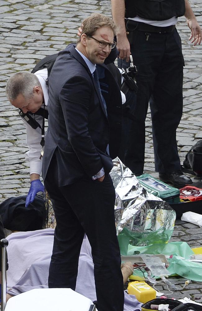 Conservative MP Tobias Ellwood, centre, stands amongst the emergency services at the scene outside the Palace of Westminster, London, Wednesday, March 22, 2017. Picture: Stefan Rousseau/PA via AP