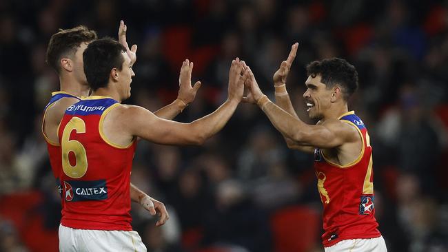 Charlie Cameron (right) celebrates kicking a goal with his Lions teammates. Picture: Daniel Pockett/Getty Images