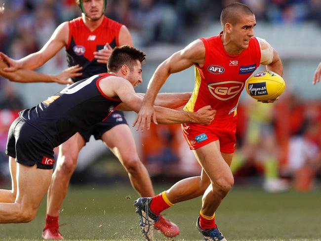 Jacob Dawson of the Suns is tackled during the Round 20 AFL match between the Melbourne Demons and the Gold Coast Suns at the MCG in Melbourne, Sunday, August 5, 2018. Picture: AAP Image, Daniel Pockett.