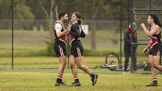 Jet Peckett (middle) celebrates with Trent Dennis-Lane, with Calvin Lee on the right. Picture: Valeriu Campan