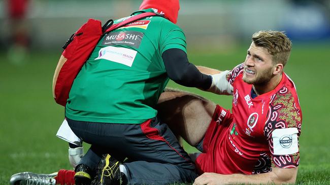 MELBOURNE, AUSTRALIA - JUNE 27: Dom Shipperley of the Reds is seen to by medical staff during the round 17 Super Rugby match between the Rebels and the Reds at AAMI Park on June 27, 2014 in Melbourne, Australia. (Photo by Robert Prezioso/Getty Images)