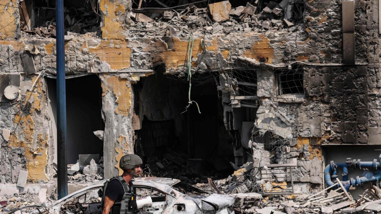 A security forces member walks past the wreckage of an Israeli police station in Sderot. Picture: AFP