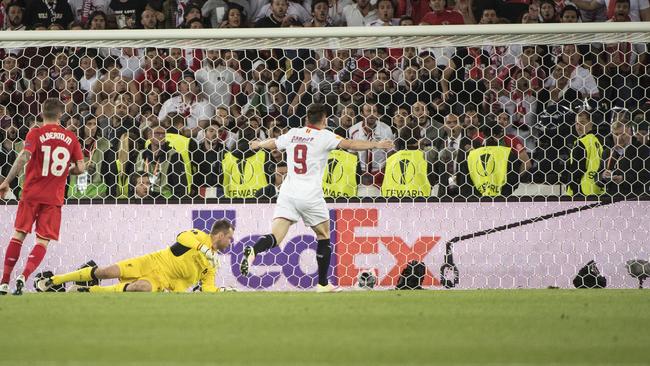 Alberto Moreno watches the ball get turned home.