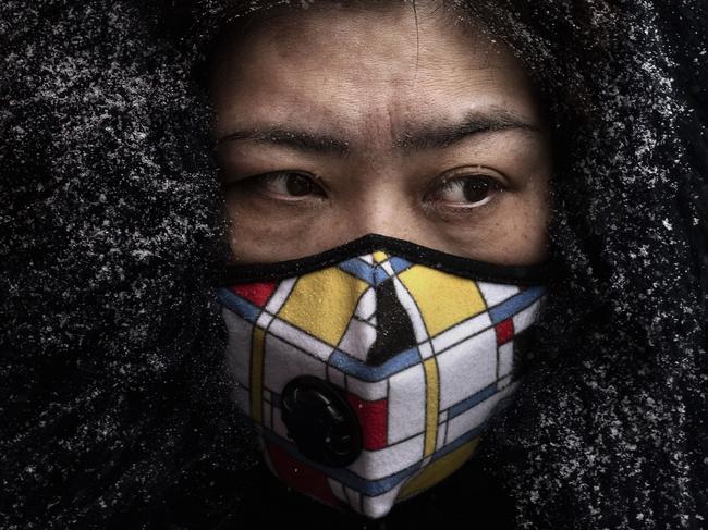 BEIJING, CHINA - FEBRUARY 06: A Chinese woman wears a protective mask as she shops in a market on February 6, 2020 in Beijing, China. The number of cases of a deadly new coronavirus rose to more than 28000 in mainland China Thursday, days after the World Health Organization (WHO) declared the outbreak a global public health emergency. China continued to lock down the city of Wuhan in an effort to contain the spread of the pneumonia-like disease which medicals experts have confirmed can be passed from human to human. In an unprecedented move, Chinese authorities have put travel restrictions on the city which is the epicenter of the virus and municipalities in other parts of the country affecting tens of millions of people. The number of those who have died from the virus in China climbed to over 564 on Thursday, mostly in Hubei province, and cases have been reported in other countries including the United States, Canada, Australia, Japan, South Korea, India, the United Kingdom, Germany, France and several others. The World Health Organization has warned all governments to be on alert and screening has been stepped up at airports around the world. Some countries, including the United States, have put restrictions on Chinese travelers entering and advised their citizens against travel to China. (Photo by Kevin Frayer/Getty Images) *** BESTPIX ***