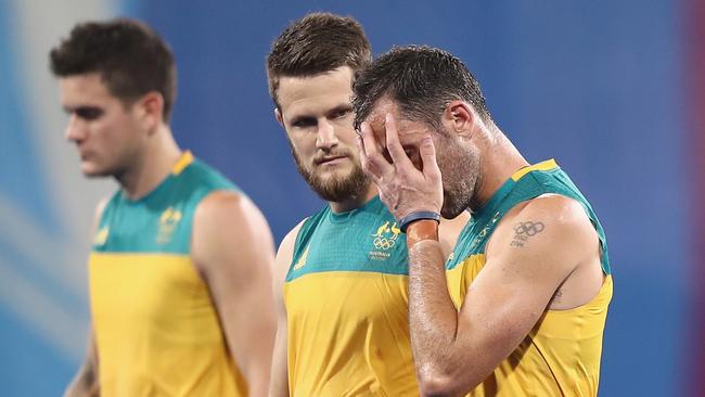 Matt Gohdes and Mark Knowles of Australia look dejected after defeat.