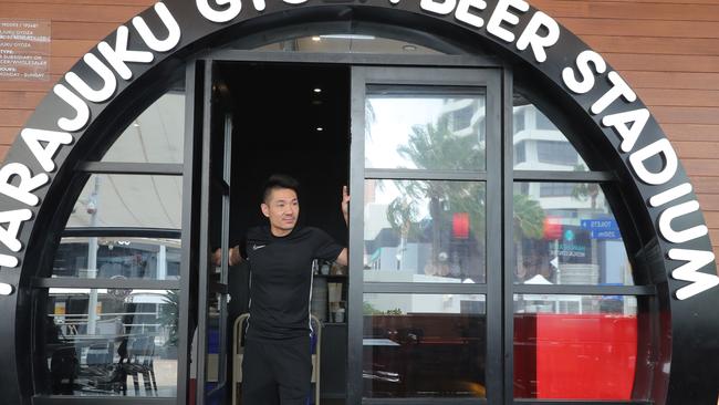 Businesses shut down in Broadbeach due to the new Coronavirus regulations. Harajuku Gyoza manager Andy Yang closes the door. Picture Glenn Hampson