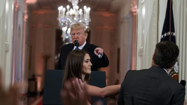 President Donald Trump orders an intern to take the microphone away from CNN’s Jim Acosta for asking a question the president didn’t like. Acosta was later stripped of his White House credentials. Picture: Evan Vucci/AP