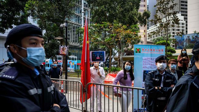 Police on hand for a demonstration by Beijing’s supporters against Jimmy Lai outside court on Monday. Picture: AFP