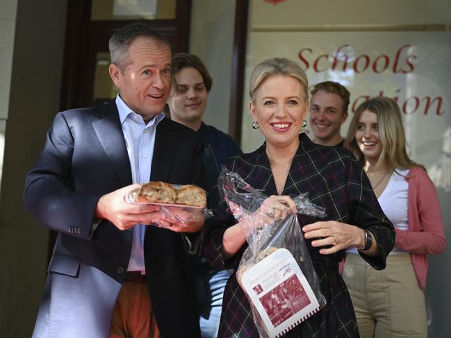 Bill Shorten and his wife Chloe offer hot cross buns to journalists during a visit to the Salvation Army’s Lighthouse Cafe in Melbourne. Picture: AAP