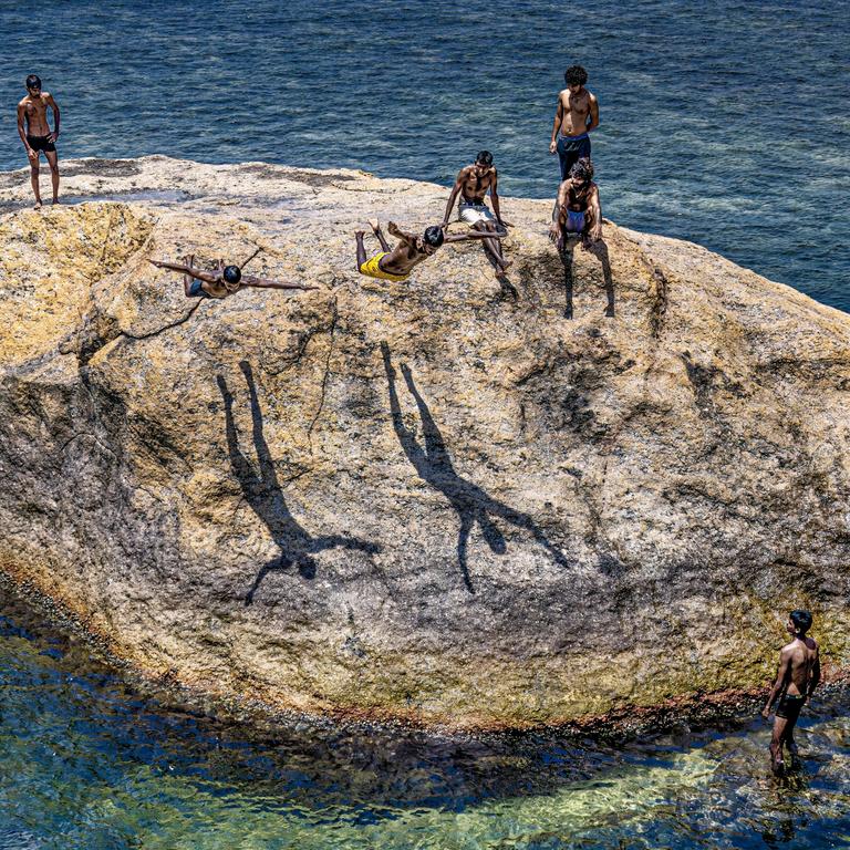 Boys jump from a rock into the ocean near the defensive walls of a colonial fortification in Sri Lanka. Picture: Ryszard Zembrzuski