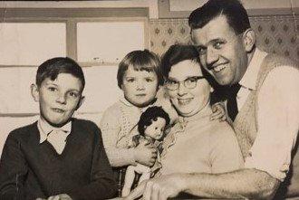 Ted and Marie Pretty, and children, looking at a map of Australia in June 1960, before moving out as '10 pound poms'.