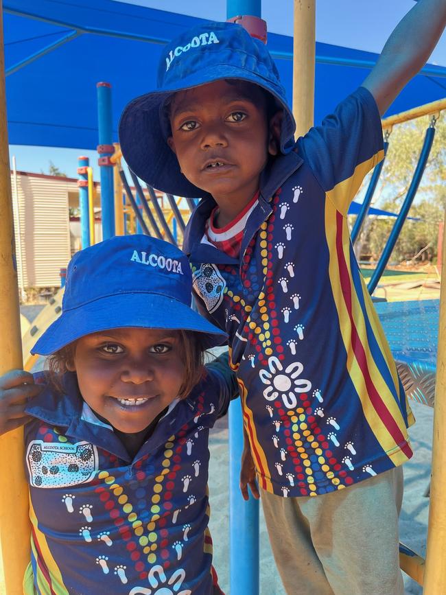 Alcoota School transition students L to R: Tayisha Inkamala, Carlos Price playing on the equipment being sun safe always wearing their hats and playing in the shade.