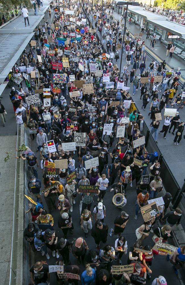 People march across the Victoria Bridge in Brisbane, Australia. Picture: Getty