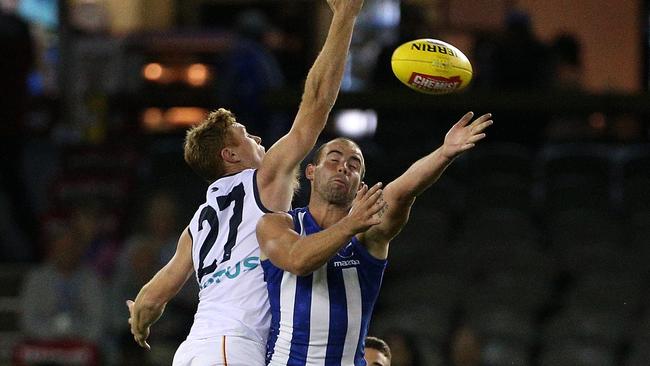 SHUT DOWN: Kangaroo Ben Cunnington contests the ball with Crow Tom Lynch at Marvel Stadium on Saturday night. Picture: HAMISH BLAIR (AAP).