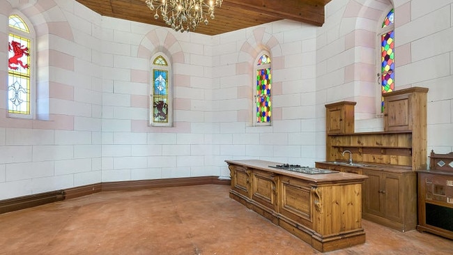 Complete with stained glass windows and a chandelier.