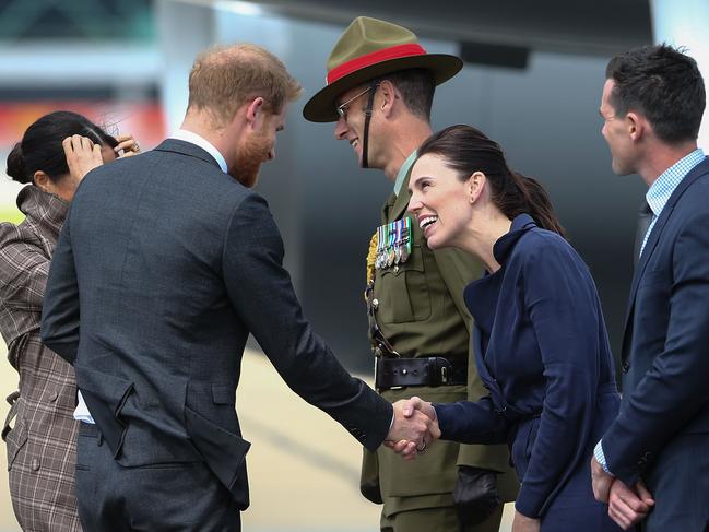 The Duke and Duchess of Sussex met New Zealand Prime Minister Jacinda Ardern as they arrived at the Wellington International Airport Military Terminal. Picture: Hagen Hopkins/Getty Images