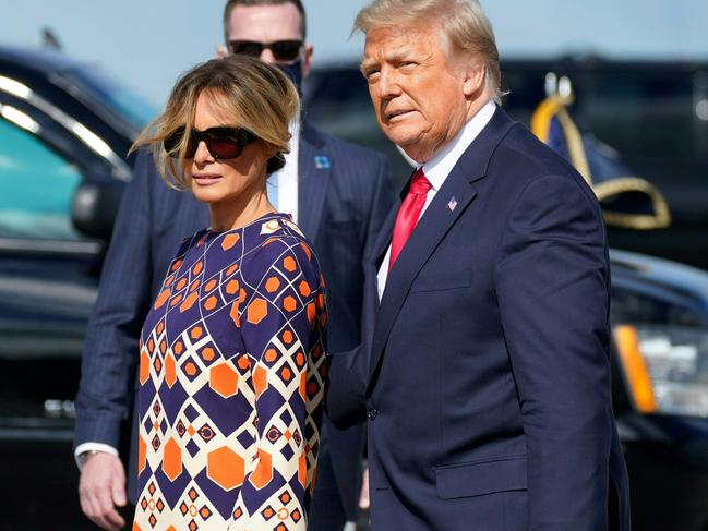 Outgoing US President Donald Trump and First Lady Melania arrive at Palm Beach International Airport in West Palm Beach, Florida, on January 20, 2021. - President Trump and the First Lady travel to their Mar-a-Lago golf club residence in Palm Beach, Florida, and will not attend the inauguration for President-elect Joe Biden. (Photo by ALEX EDELMAN / AFP)