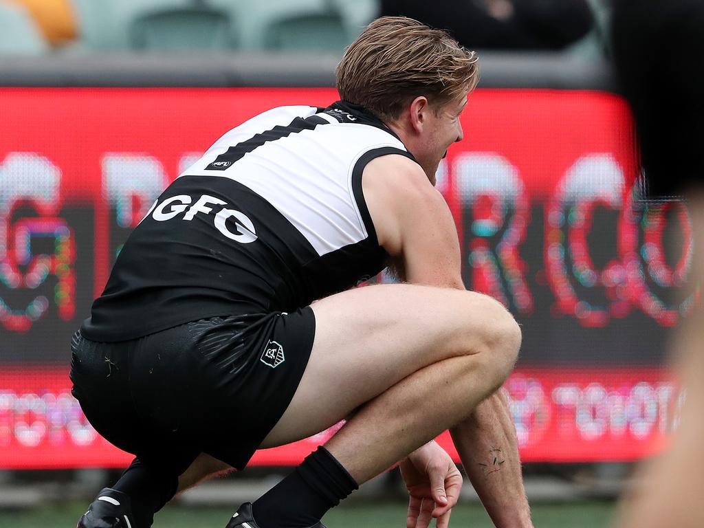 Tom Jonas down after getting hit in the groin by Richmond’s Jack Riewoldt. Picture: Sarah Reed