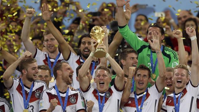 Germany's Bastian Schweinsteiger holds up the World Cup trophy.